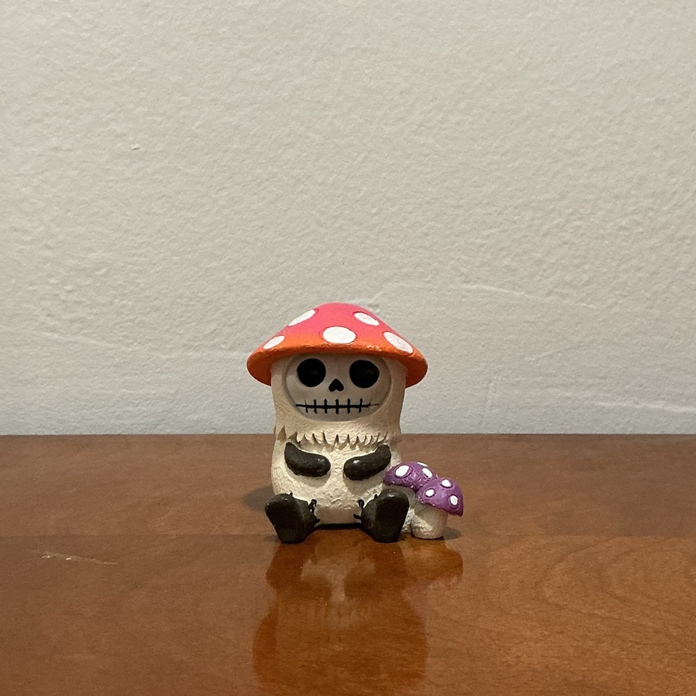 Whimsical Skeleton Figurine with Red and Purple Accents